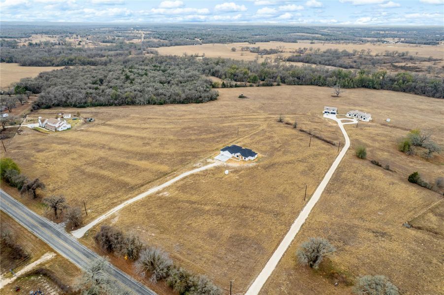 Aerial view of property and surrounding area featuring rural landscape