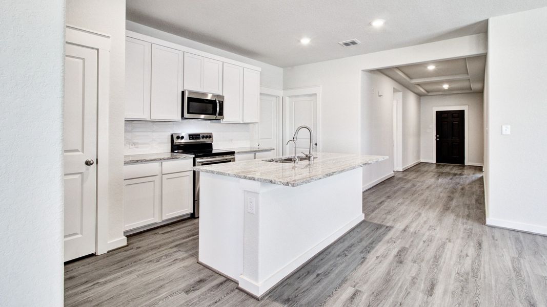 Representative furnished interior of a home built from the Paramount by Brightland Homes in Sunterra, Katy (Image 5).