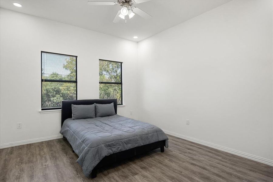 Bedroom featuring dark hardwood / wood-style floors and ceiling fan