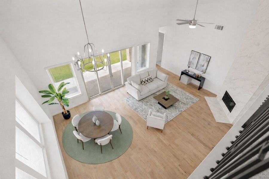 Whether it's a simple night in or entertaining family and friends, this home has ample open space for everyone to enjoy! Stunning open-concept filled with natural light, soaring ceilings, and beautiful wood look flooring throughout. The inviting layout seamlessly connects the dining and living areas, sleek modern chandelier, & anchored fireplace tiled from floor to ceiling.