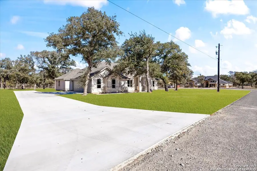 Front exterior of a new home in , La Vernia, TX, highlighting curb appeal (Image 1).