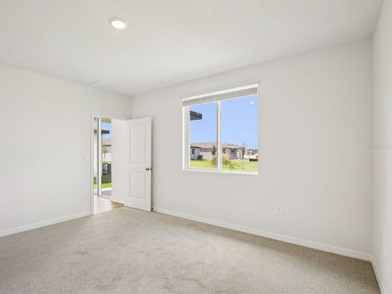 Spacious, unfurnished interior of a new home in The Grove at Stuart Crossing - Premier Series, Bartow (Image 12).