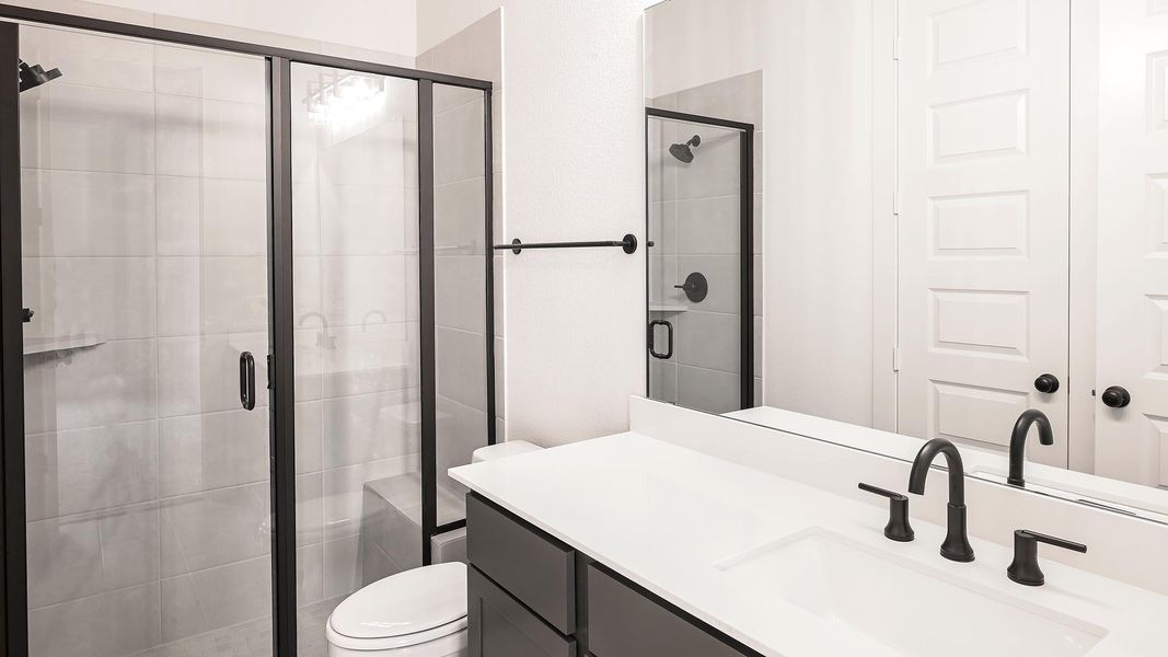 Full bath with vanity and a shower stall