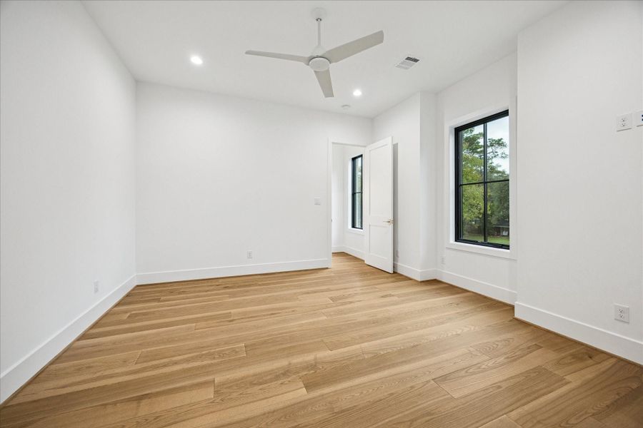 Bright natural light, wide-plank oak floors, Emtek hardware, and tall 8 ft doors create a modern, elevated feel.
