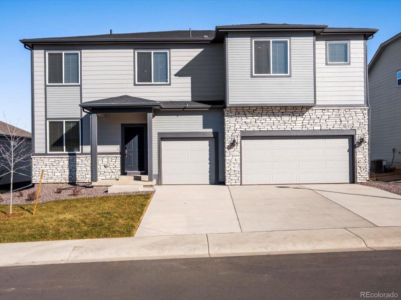 Front exterior of a new home in Poudre Heights: The Alpine Collection, Windsor, CO, highlighting curb appeal (Image 1). Front exterior of a new home in Poudre Heights: The Alpine Collection, Windsor, CO, highlighting curb appeal (Image 1).