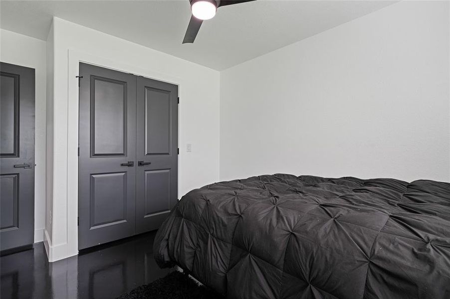 Bedroom with ceiling fan and a closet