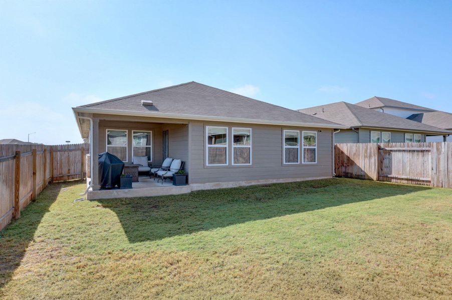 Rear view of property with a patio area and a fenced backyard Rear view of property with a patio area and a fenced backyard