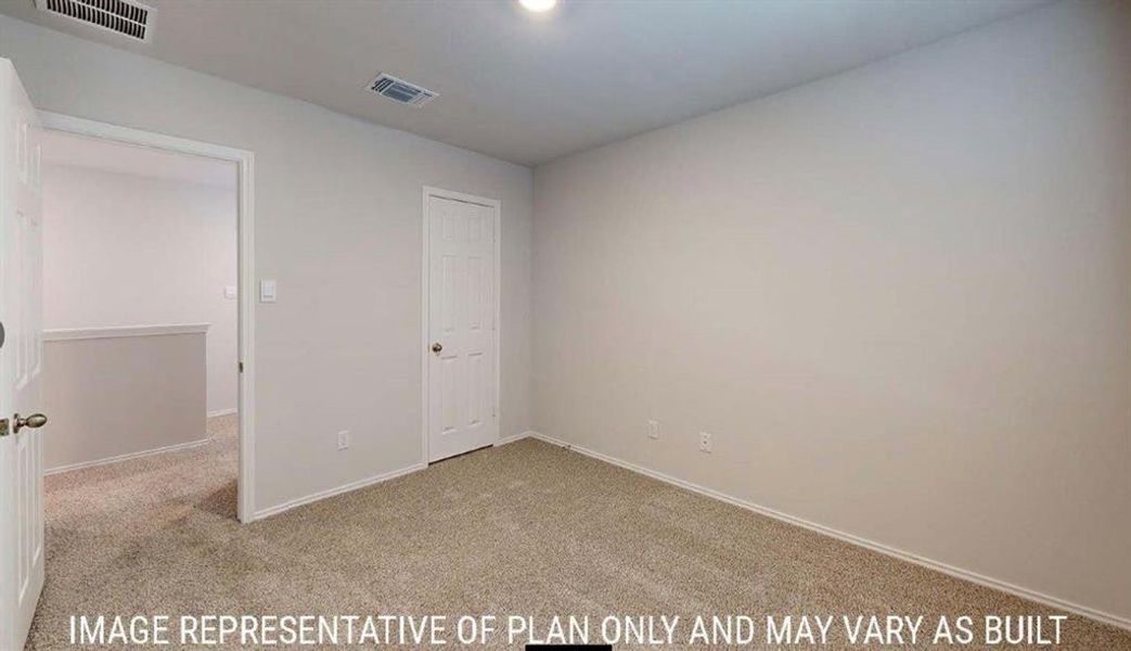 Carpeted interior room with light-colored walls and white trim