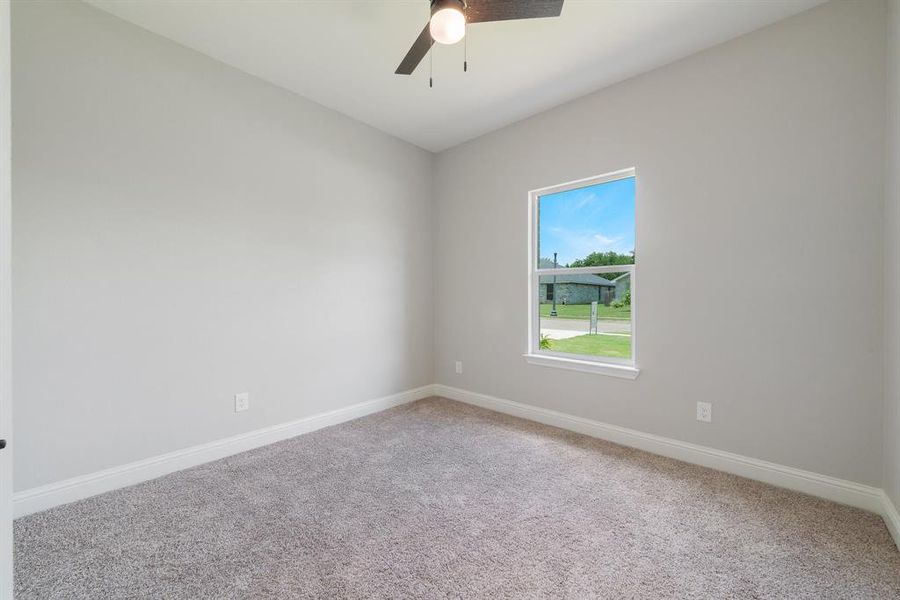 Spare room with carpet and ceiling fan