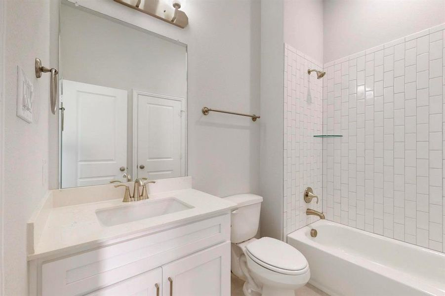 Bathroom featuring washtub / shower combination and vanity