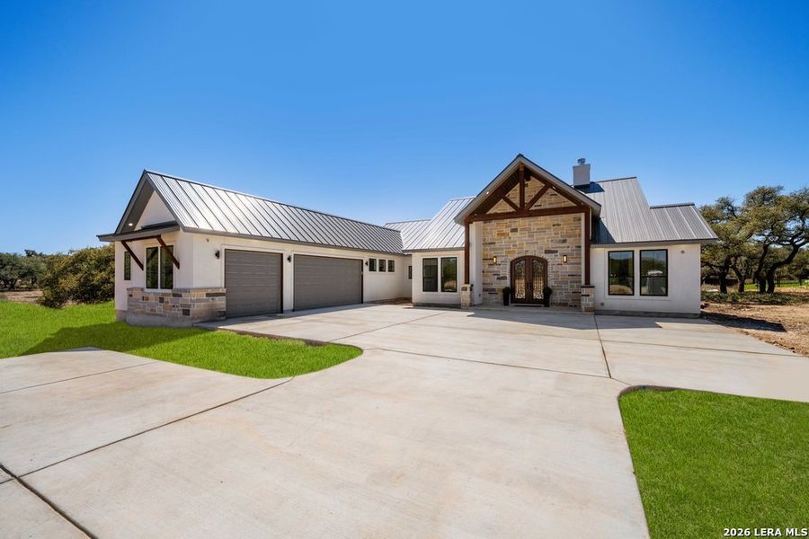 Front exterior of a new home in , Bulverde, TX, highlighting curb appeal (Image 27).
