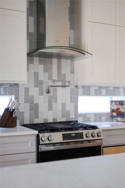 Instant hot water tap over the GAS five burner range. Ribbon windows below the cabinets provide natural light and retain privacy. Instant hot water tap over the GAS five burner range. Ribbon windows below the cabinets provide natural light and retain privacy.