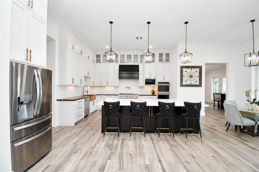 Kitchen with oversized island and GE Monogram appliances