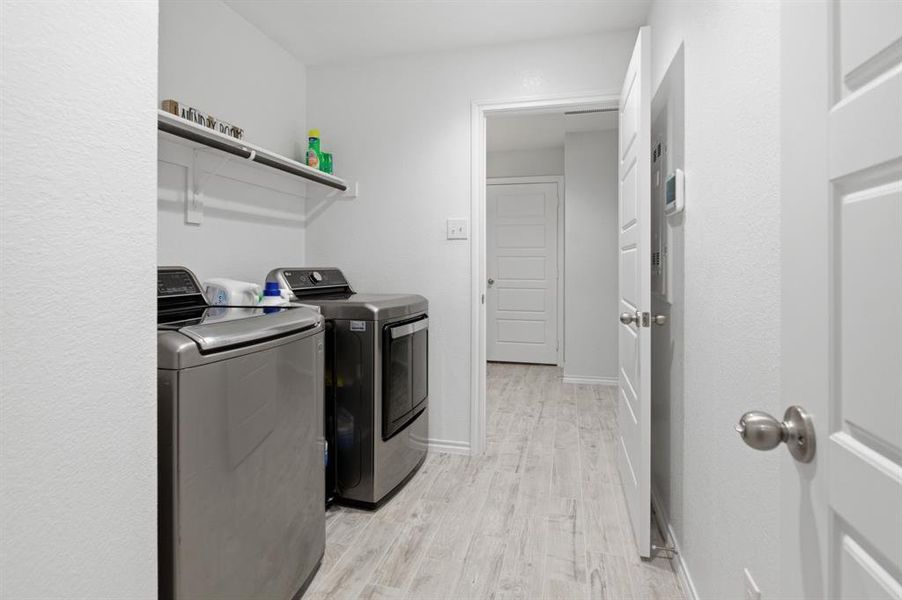 Laundry room is attached to oversized closet space from Primary bathroom