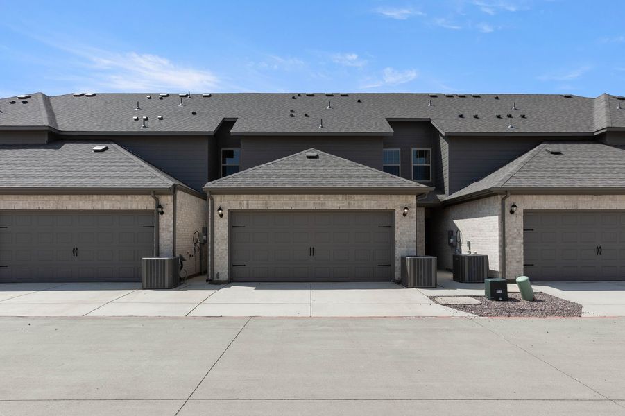 Front exterior of a new home in Sanger Circle – Townhomes, Sanger, TX, highlighting curb appeal (Image 28). Front exterior of a new home in Sanger Circle – Townhomes, Sanger, TX, highlighting curb appeal (Image 28).