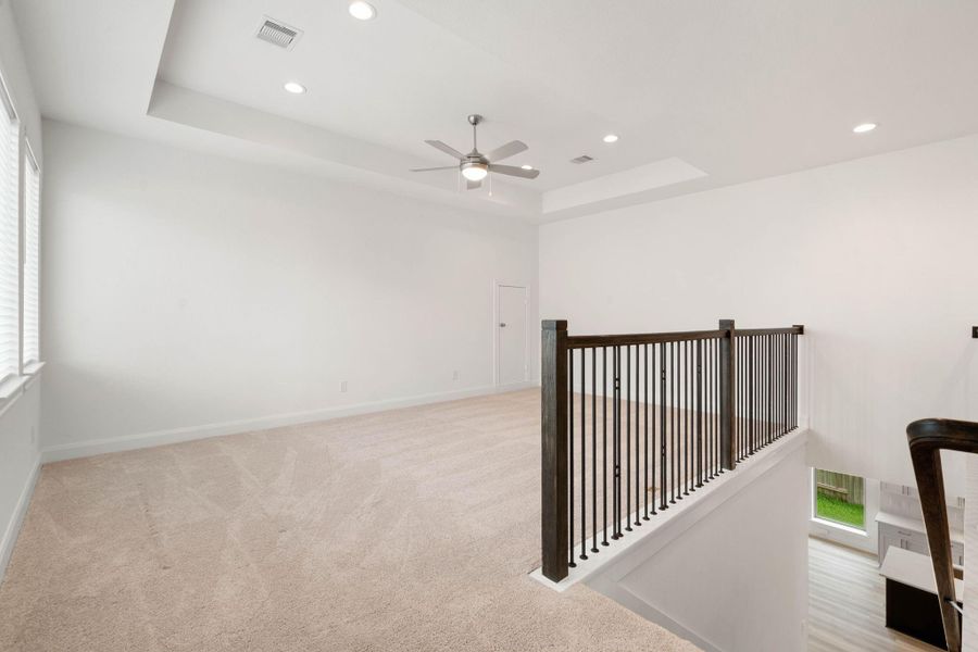 Upstairs a carpeted game room adds extra space to hang out and relax in.
