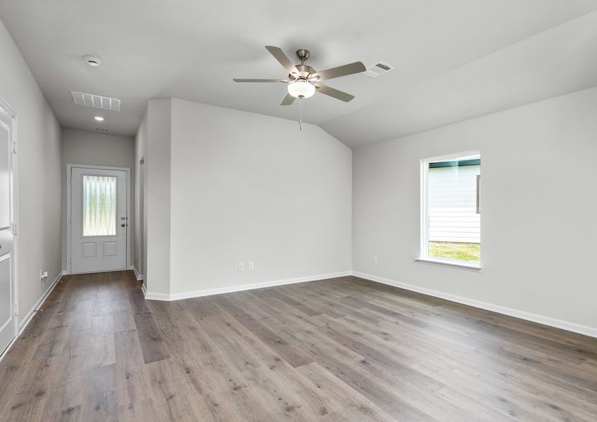 The living room is spacious and has plenty of space for furniture.