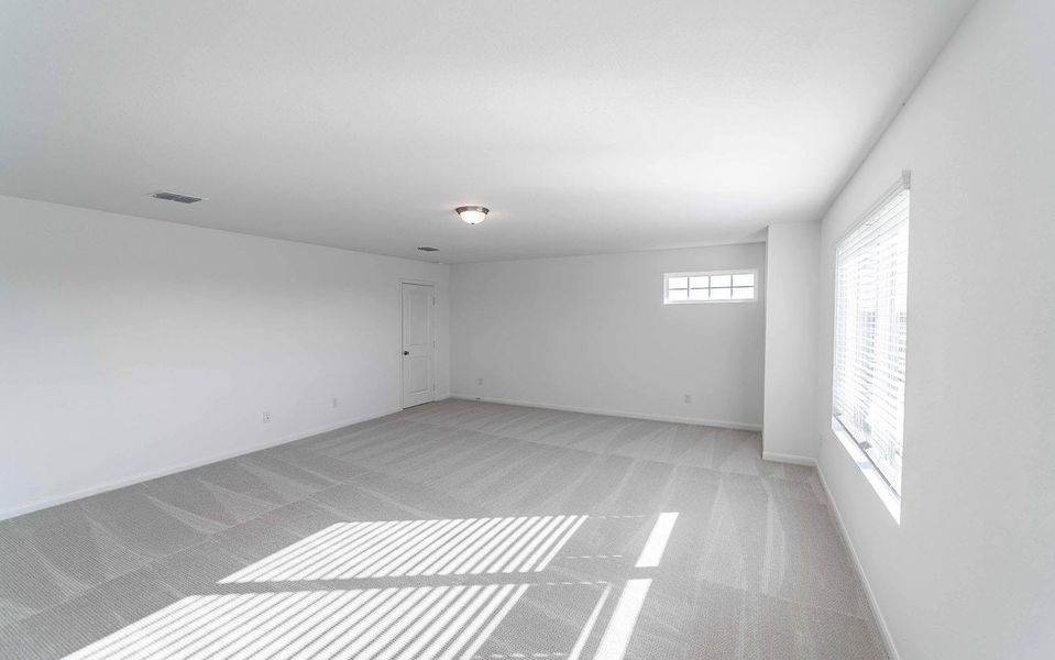 Empty room with light colored carpet and baseboards Empty room with light colored carpet and baseboards