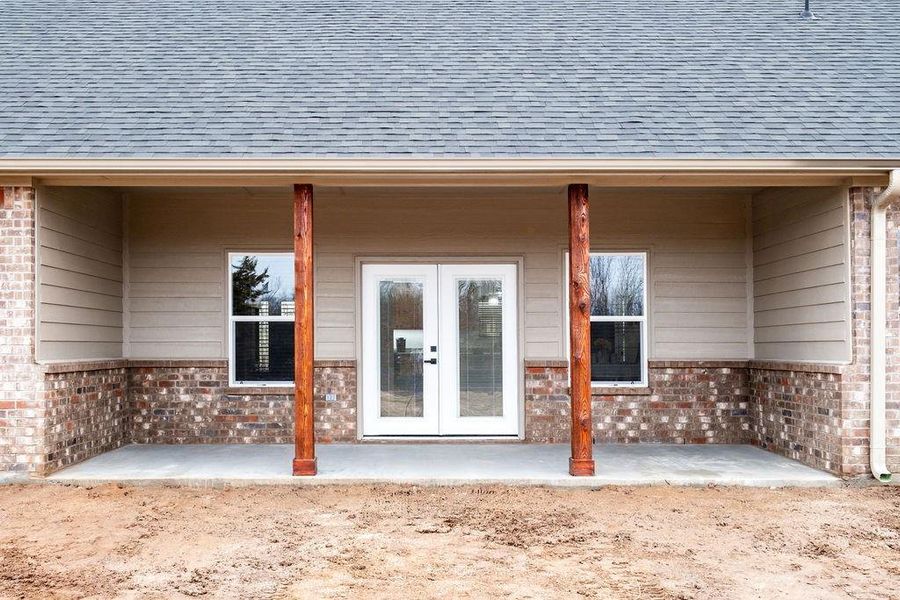 Entrance to property featuring a patio and french doors