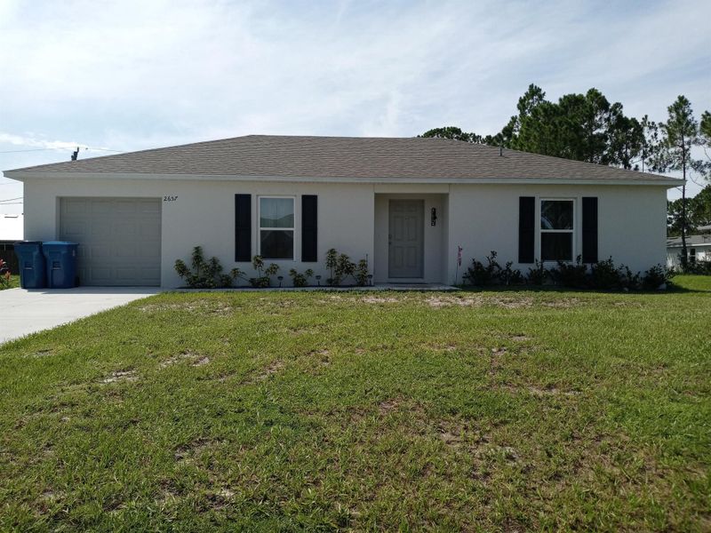 Front exterior of a new home in , Palm Bay, FL, highlighting curb appeal (Image 19).