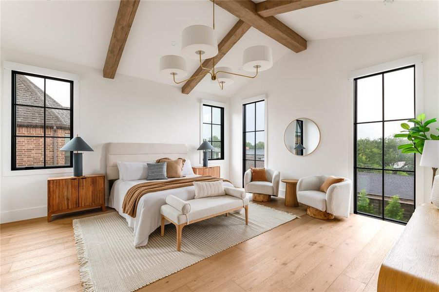 Bedroom featuring multiple windows, hardwood / wood-style flooring, and a chandelier