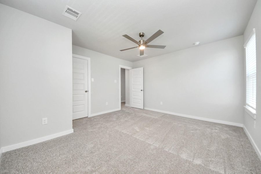 Generously sized secondary bedrooms featuring spacious closets, soft and inviting carpeting underfoot, large windows allowing plenty of natural light, and the added touch of privacy blinds for your personal retreat.