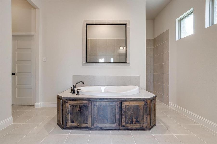 Bathroom featuring tile patterned flooring and a washtub