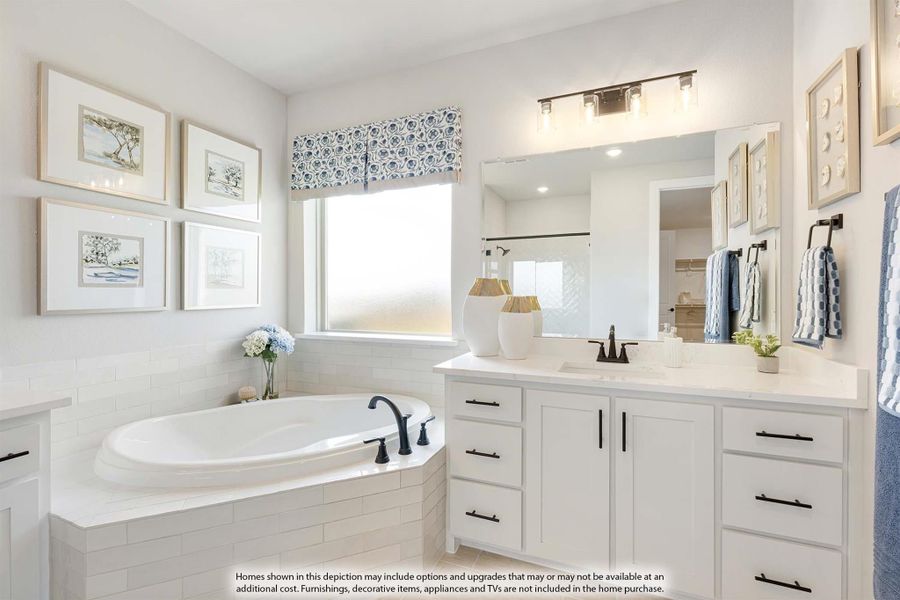 Master bathroom with soaking tub, white vanity cabinets, large mirror, and natural light from a window