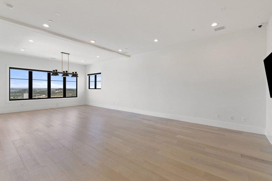 City views frame this generously proportioned living area, featuring light hardwood floors and abundant natural light.
