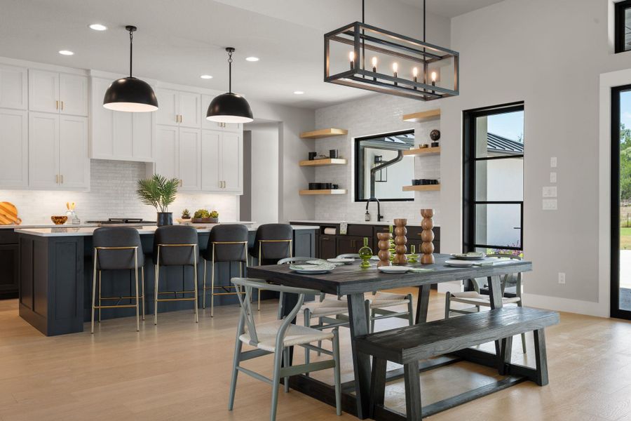 An open floorplan seamlessly connects the airy culinary space with a light-filled dining area.
