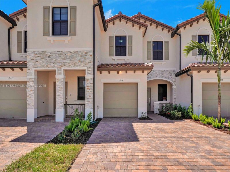 Front exterior of a new home in , Homestead, FL, highlighting curb appeal (Image 1). Front exterior of a new home in , Homestead, FL, highlighting curb appeal (Image 1).