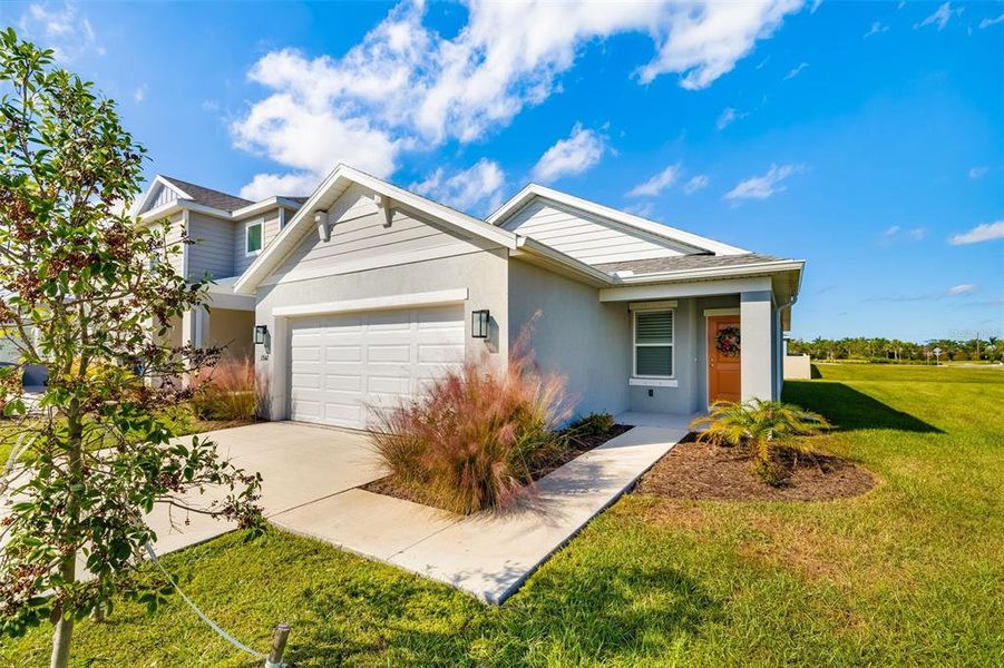 Front exterior of a new home in Broadleaf, Parrish, FL, highlighting curb appeal (Image 2).