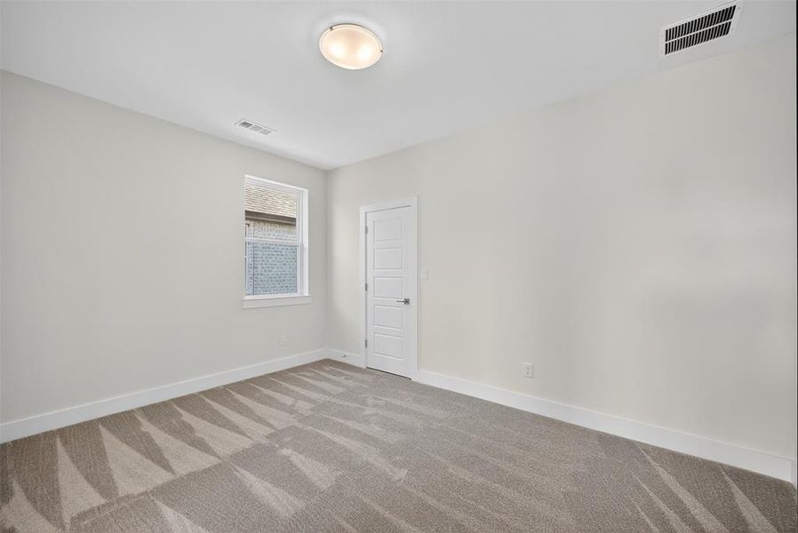 Carpeted empty room with baseboards Carpeted empty room with baseboards