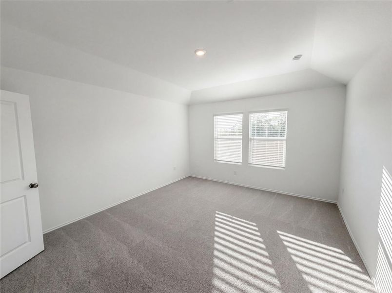 Spare room with carpet, lofted ceiling, and recessed lighting