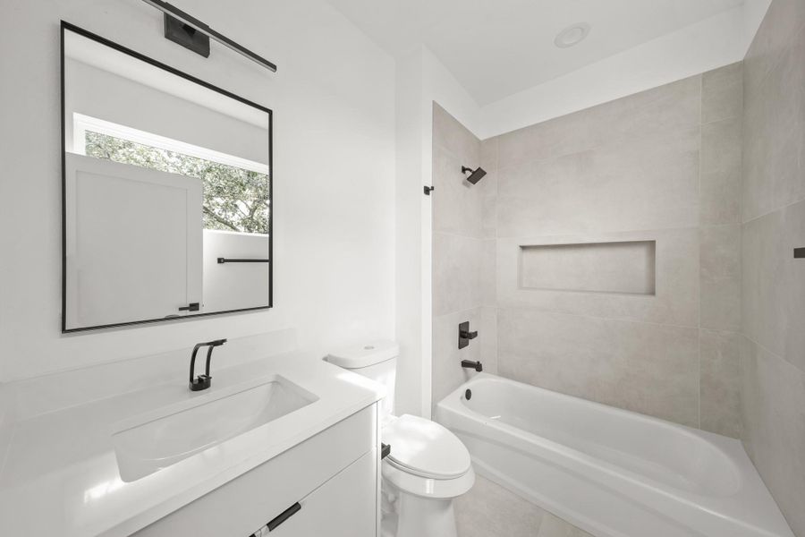 Bright and cheery, the private bath includes a Quartz counter with an under mount sink with cabinets below and a black-framed mirror. Bright and cheery, the private bath includes a Quartz counter with an under mount sink with cabinets below and a black-framed mirror.