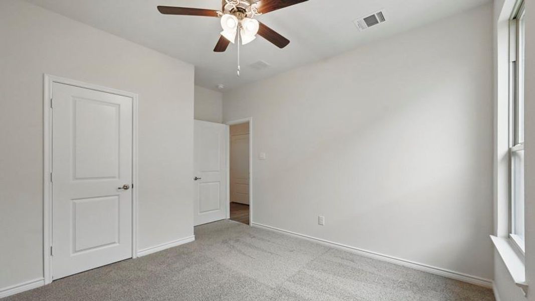 Carpeted room with white walls and trim