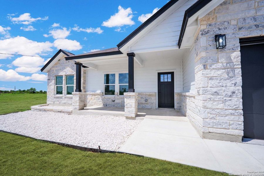 Front exterior of a new home in , Natalia, TX, highlighting curb appeal (Image 18). Front exterior of a new home in , Natalia, TX, highlighting curb appeal (Image 18).