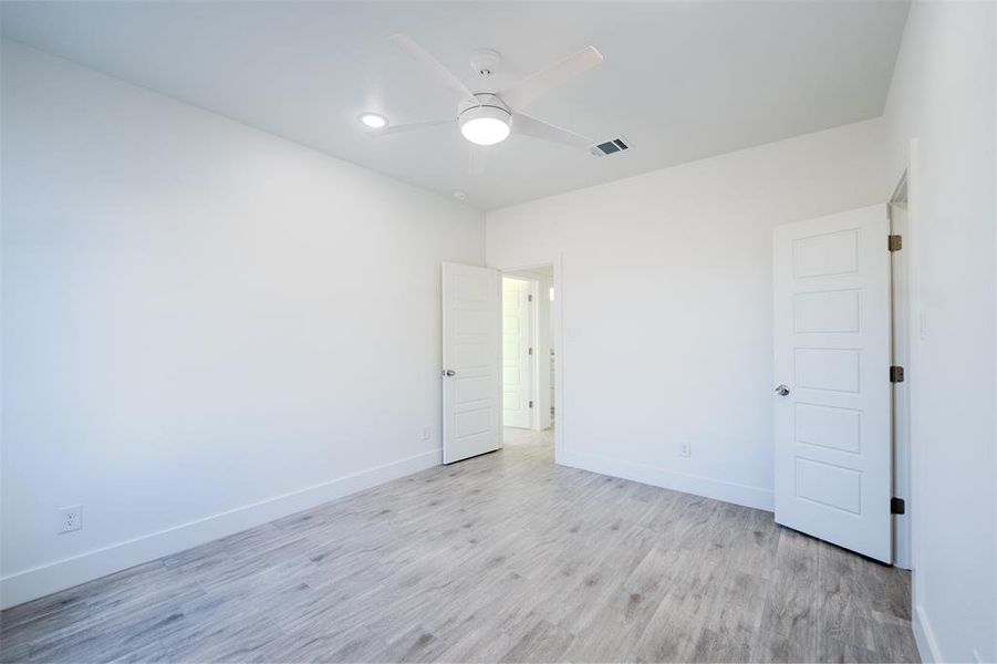 Bedroom (3) room featuring light wood-type flooring and ceiling fan Bedroom (3) room featuring light wood-type flooring and ceiling fan