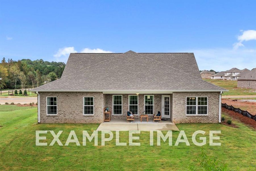 Rear view of house with a patio and a lawn