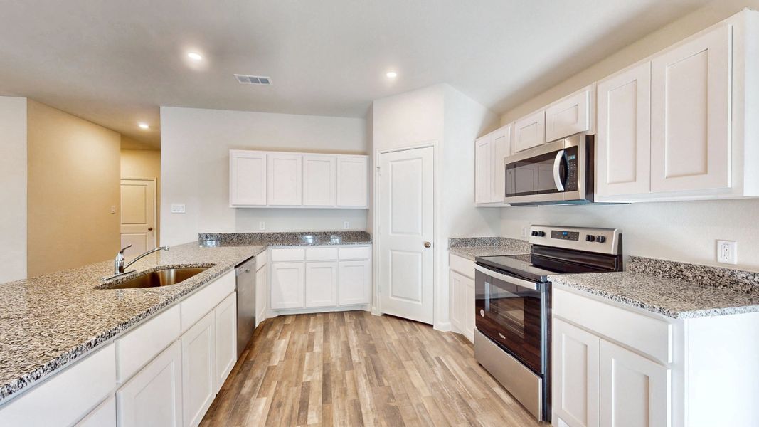 A kitchen with white cabinets. A kitchen with white cabinets.