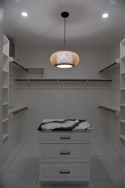 Spacious closet with light tile patterned floors