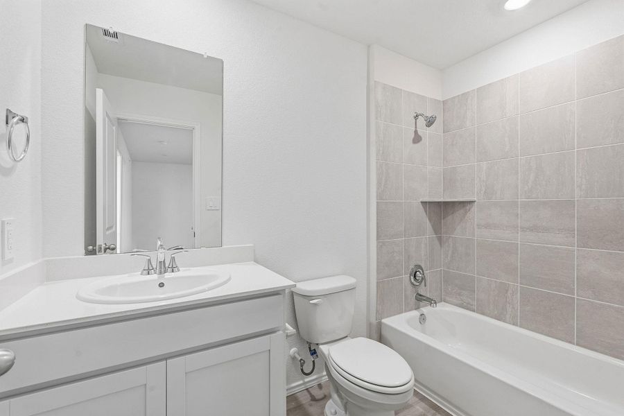 Bathroom featuring a white vanity with a rectangular sink, a polished chrome faucet, and a large mirror Bathroom featuring a white vanity with a rectangular sink, a polished chrome faucet, and a large mirror
