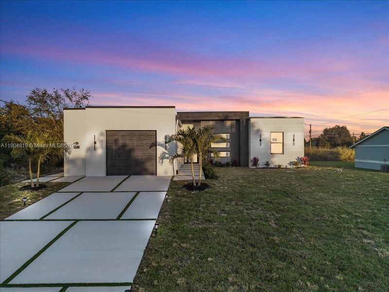 Front exterior of a new home in , Lehigh Acres, FL, highlighting curb appeal (Image 23).