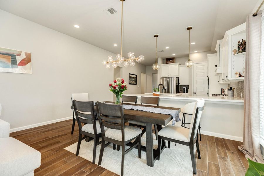 Dining area is perfect for entertaining with modern light fixtures. Dining area is perfect for entertaining with modern light fixtures.