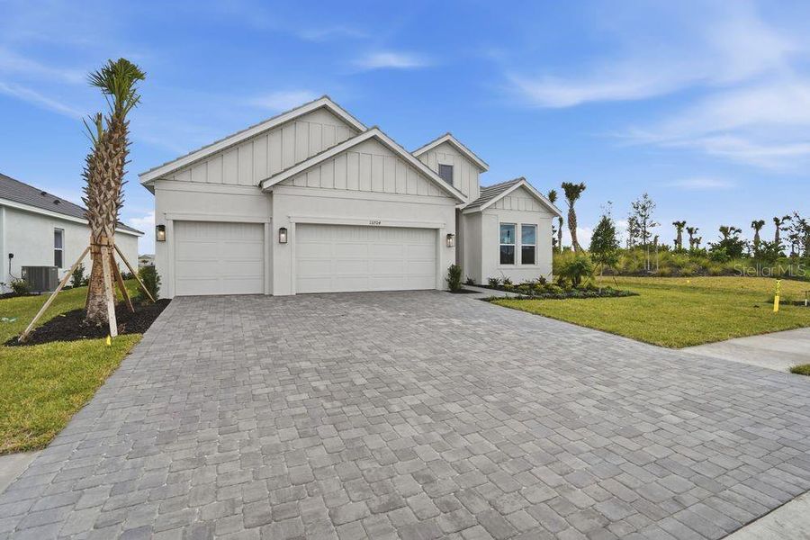 Front exterior of a new home in Coasterra Community Group Page, Palmetto, FL, highlighting curb appeal (Image 19).