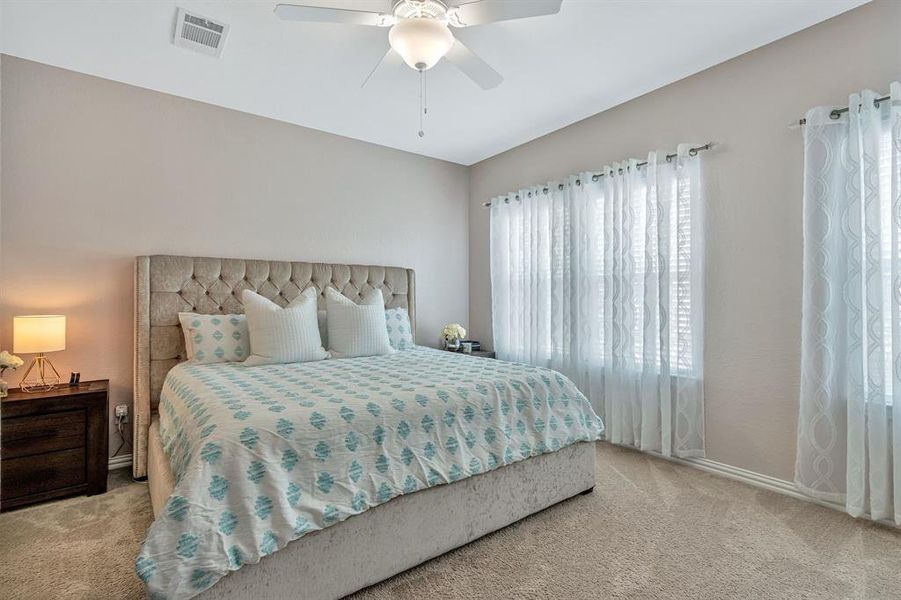 Bedroom featuring ceiling fan and light colored carpet