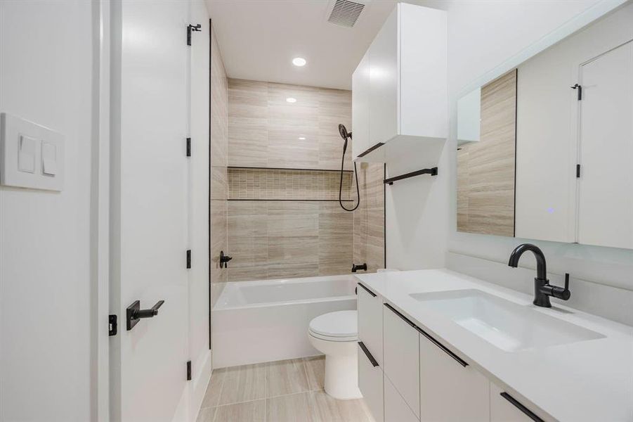 Bathroom with shower combination, vanity, and recessed lighting Bathroom with shower combination, vanity, and recessed lighting