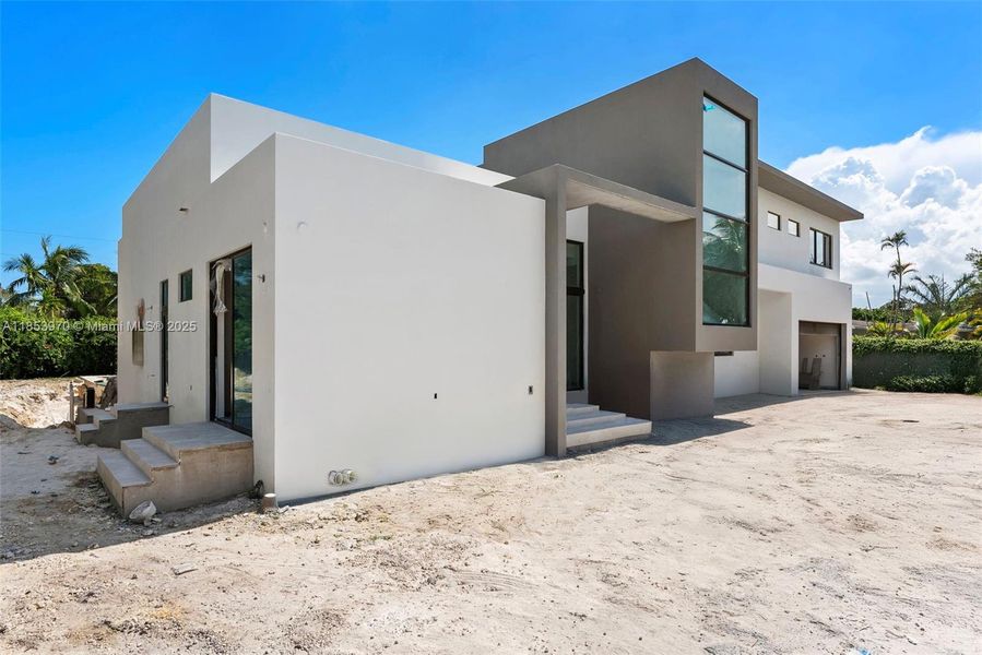 Front exterior of a new home in , Pinecrest, FL, highlighting curb appeal (Image 25). Front exterior of a new home in , Pinecrest, FL, highlighting curb appeal (Image 25).