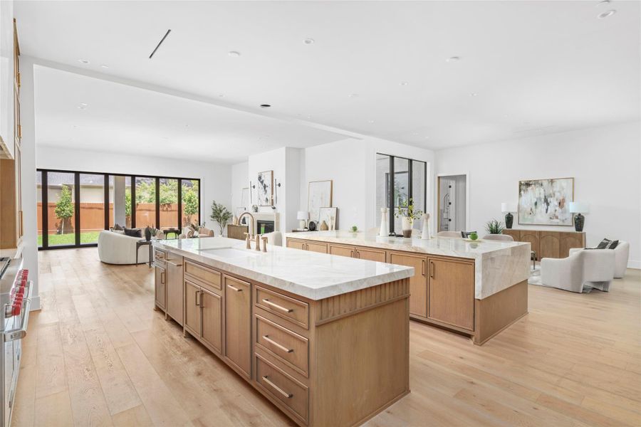 Double Islands finished with Taj Mahal Quartzite and custom wood finishes are the centerpiece of the living space. Perfect for functional living and easy entertaining.