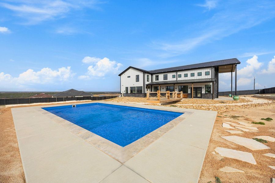 View of swimming pool featuring a patio area View of swimming pool featuring a patio area